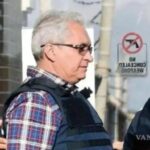 Royalty-Free photo: Man wearing sport shirt in front of question mark ...